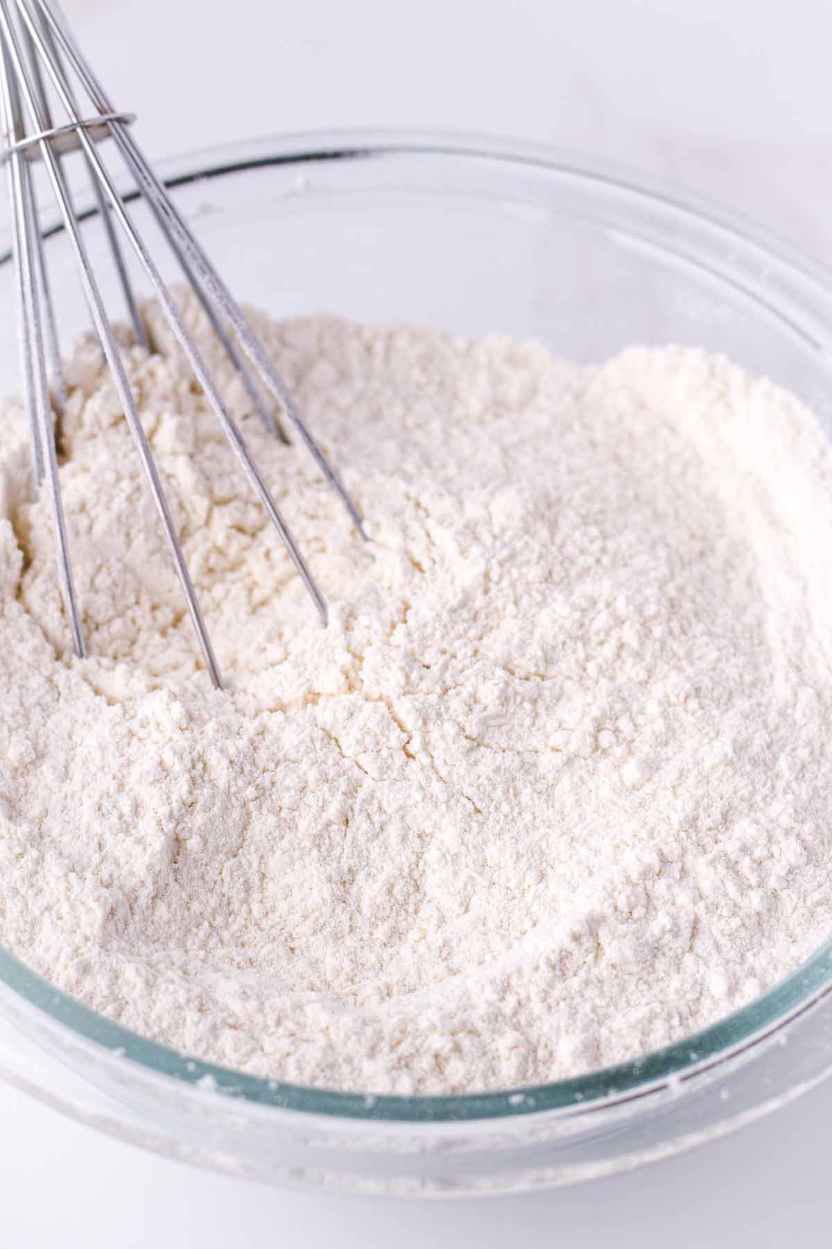 whisking dry ingredients in a mixing bowl