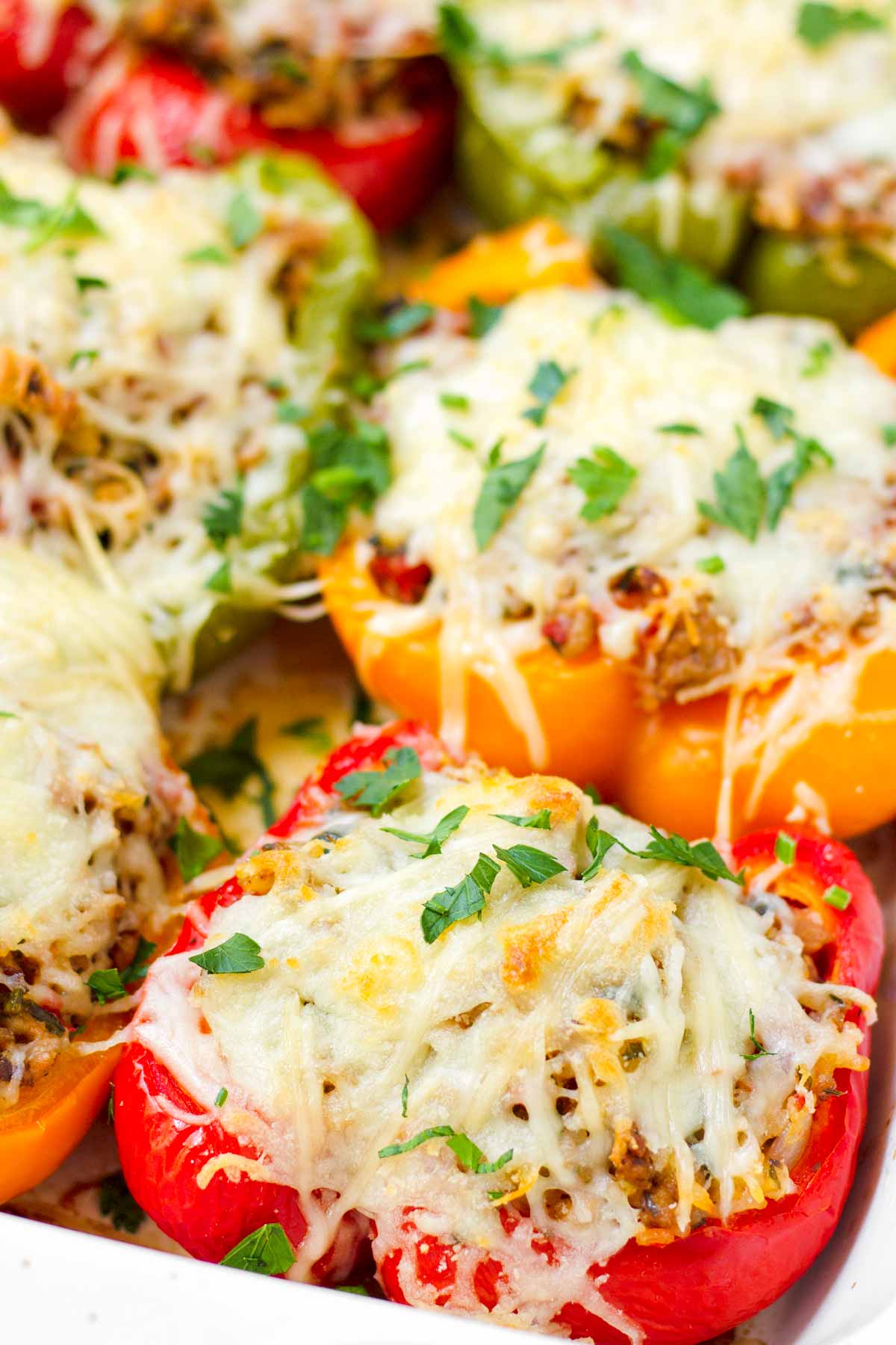 melted cheese on top of turkey and rice stuffed peppers