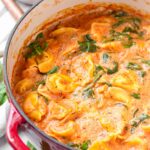 cheese tortellini and creamy tomato soup in a dutch oven pot