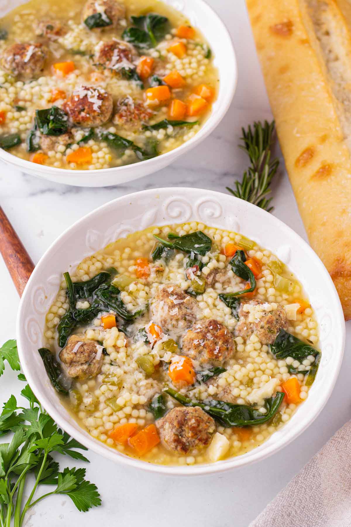 two bowls of italian soup with meatballs and pasta