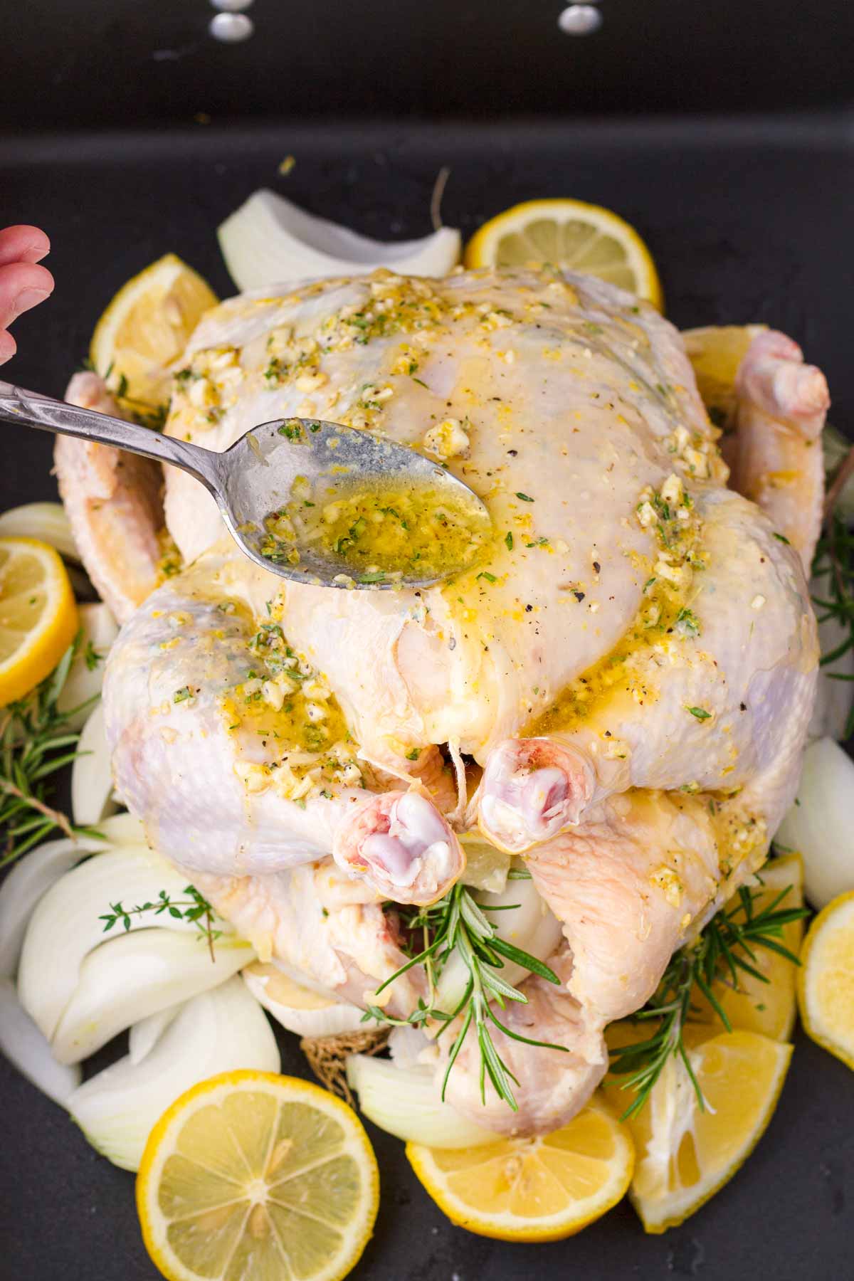 drizzling exterior of chicken with lemon garlic butter