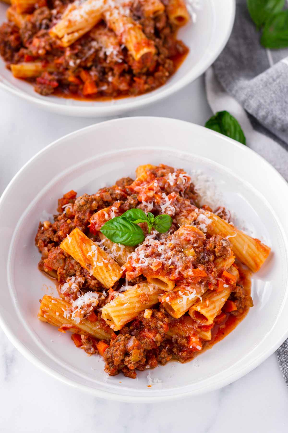 two bowls of served pasts with bolognese sauce