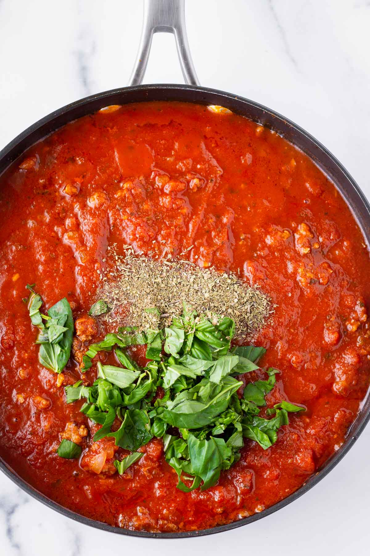 base tomato meat sauce with herb seasoning and fresh basil