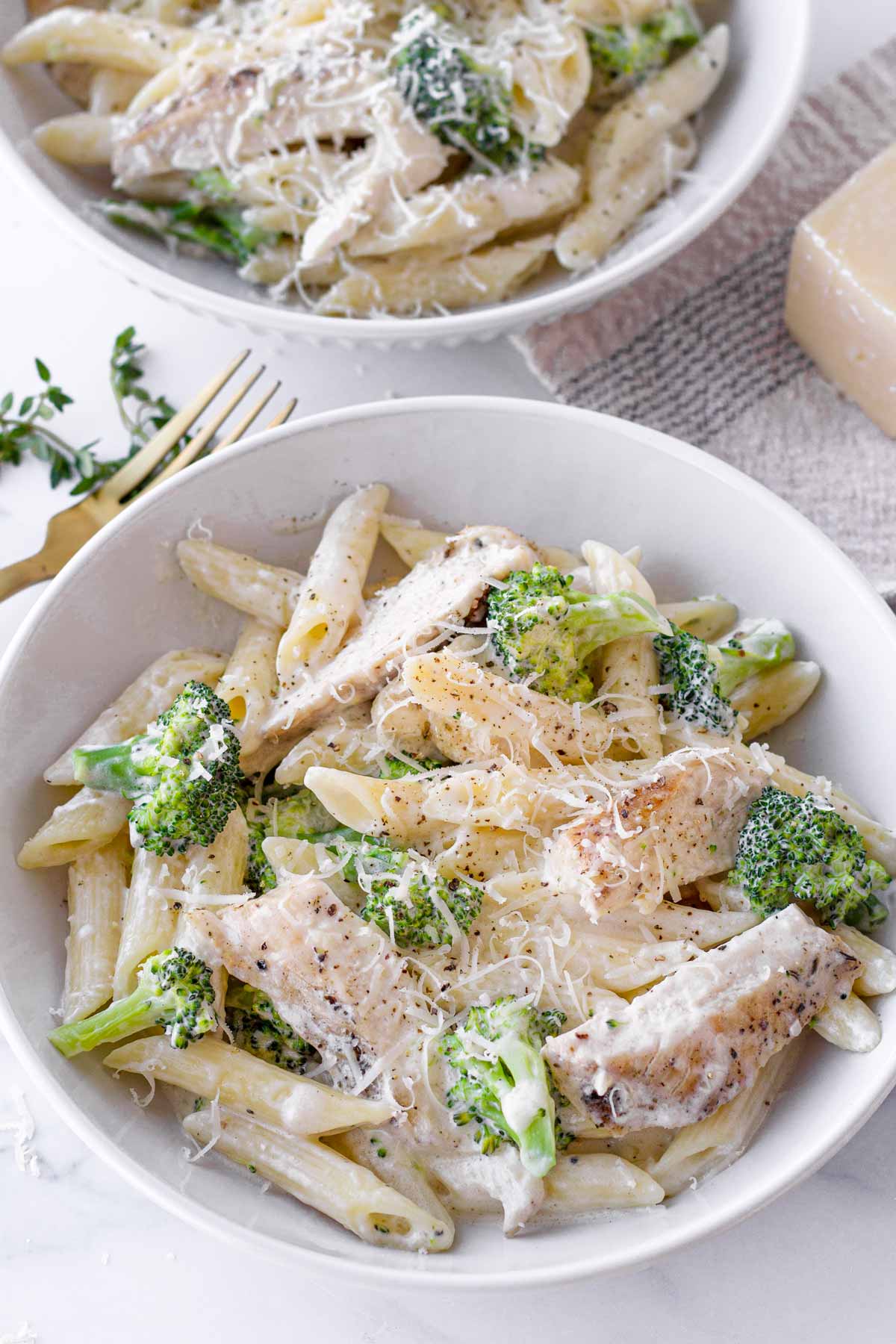 chicken broccoli alfredo with parmesan cheese garnish