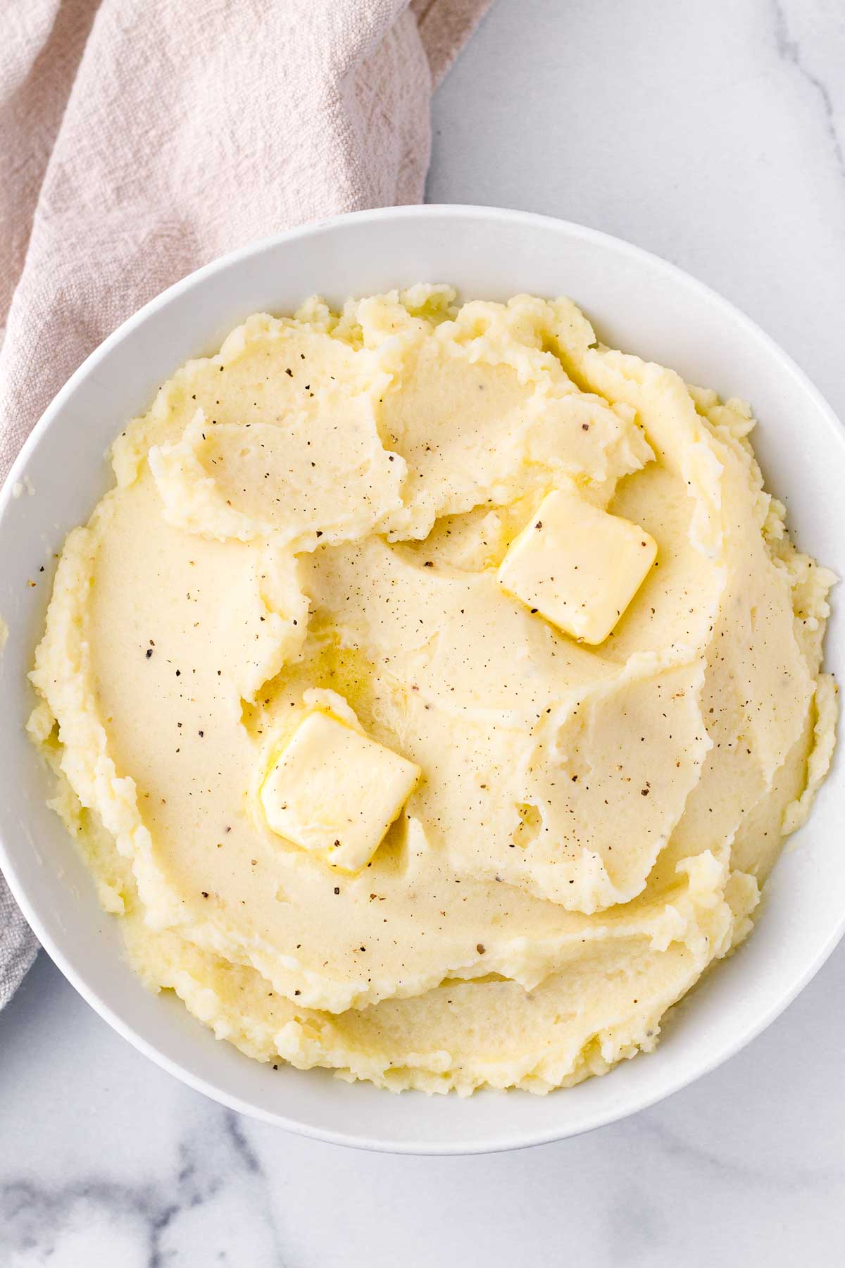fluffy mashed potatoes with dollops of butter on top