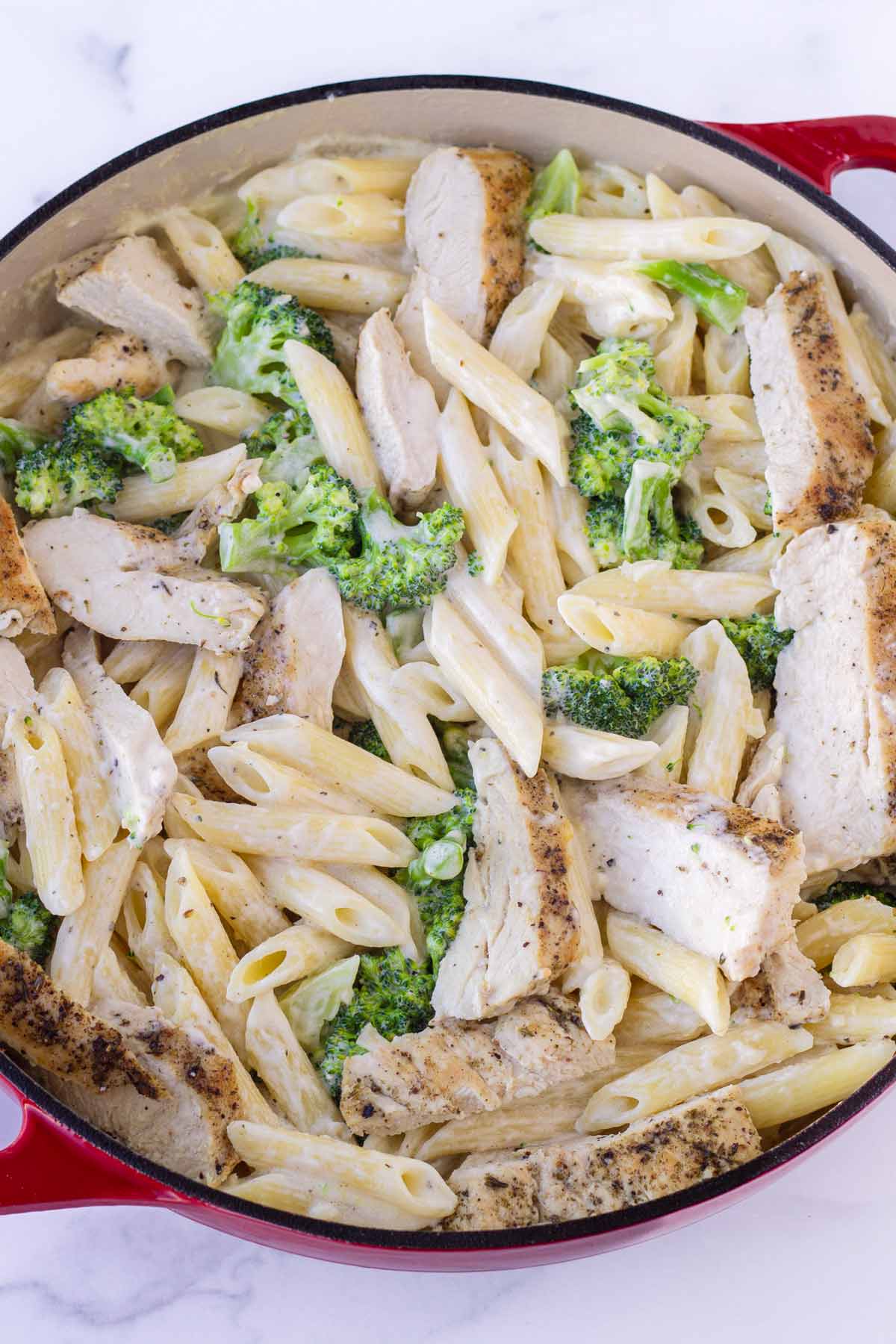 chicken and broccoli mixed with penne pasta and sauce