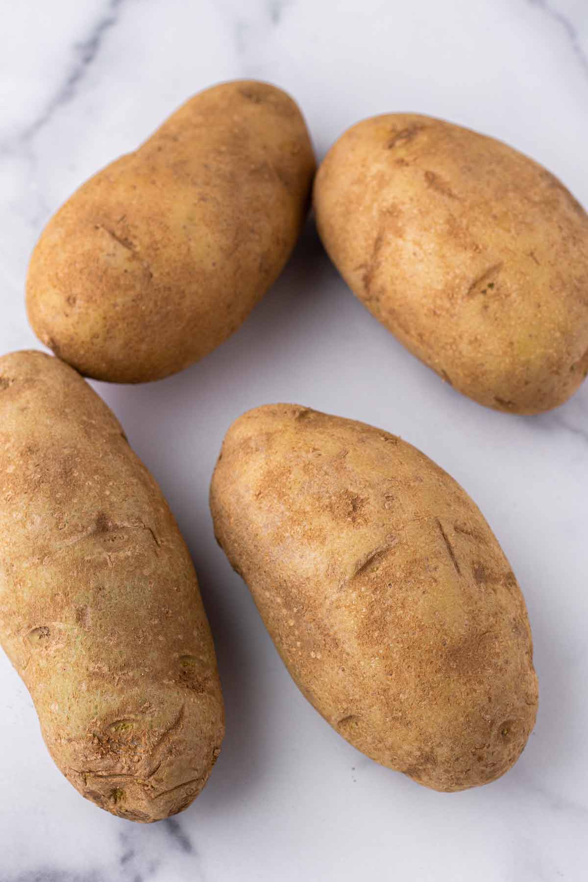 four unpeeled russet potatoes