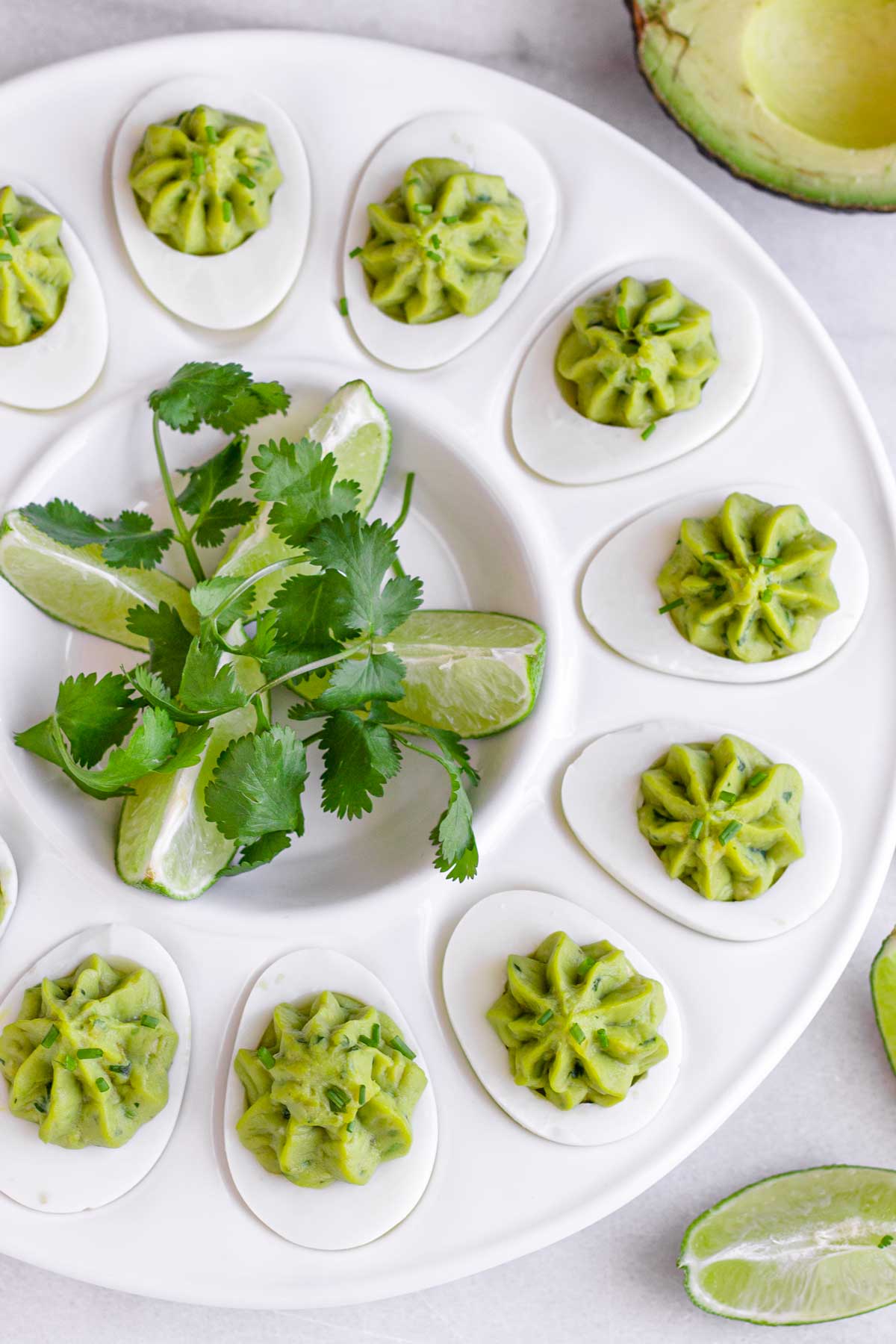 avocado deviled eggs in a decorated serving platter