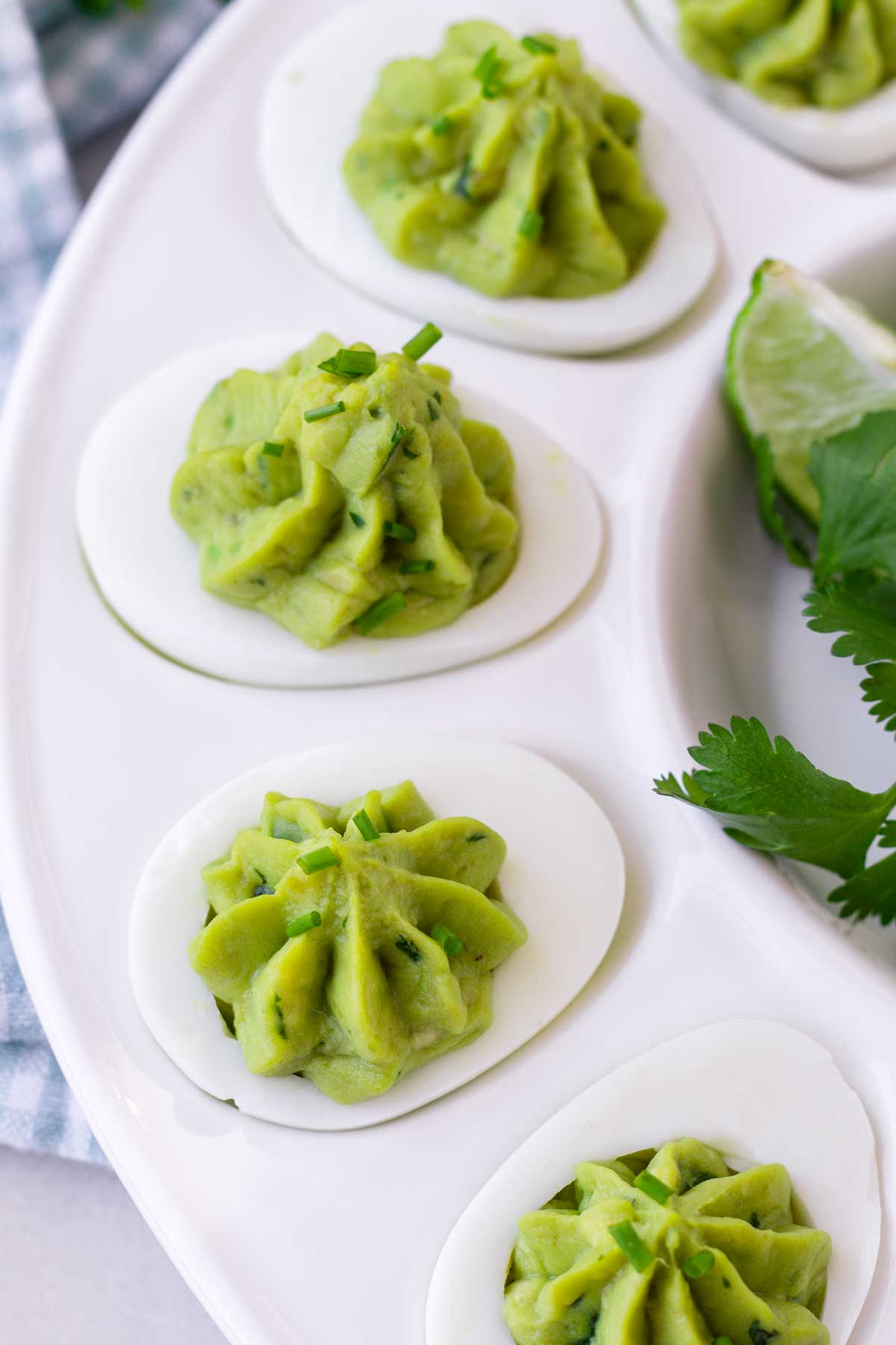 piped deviled eggs made with avocado filling