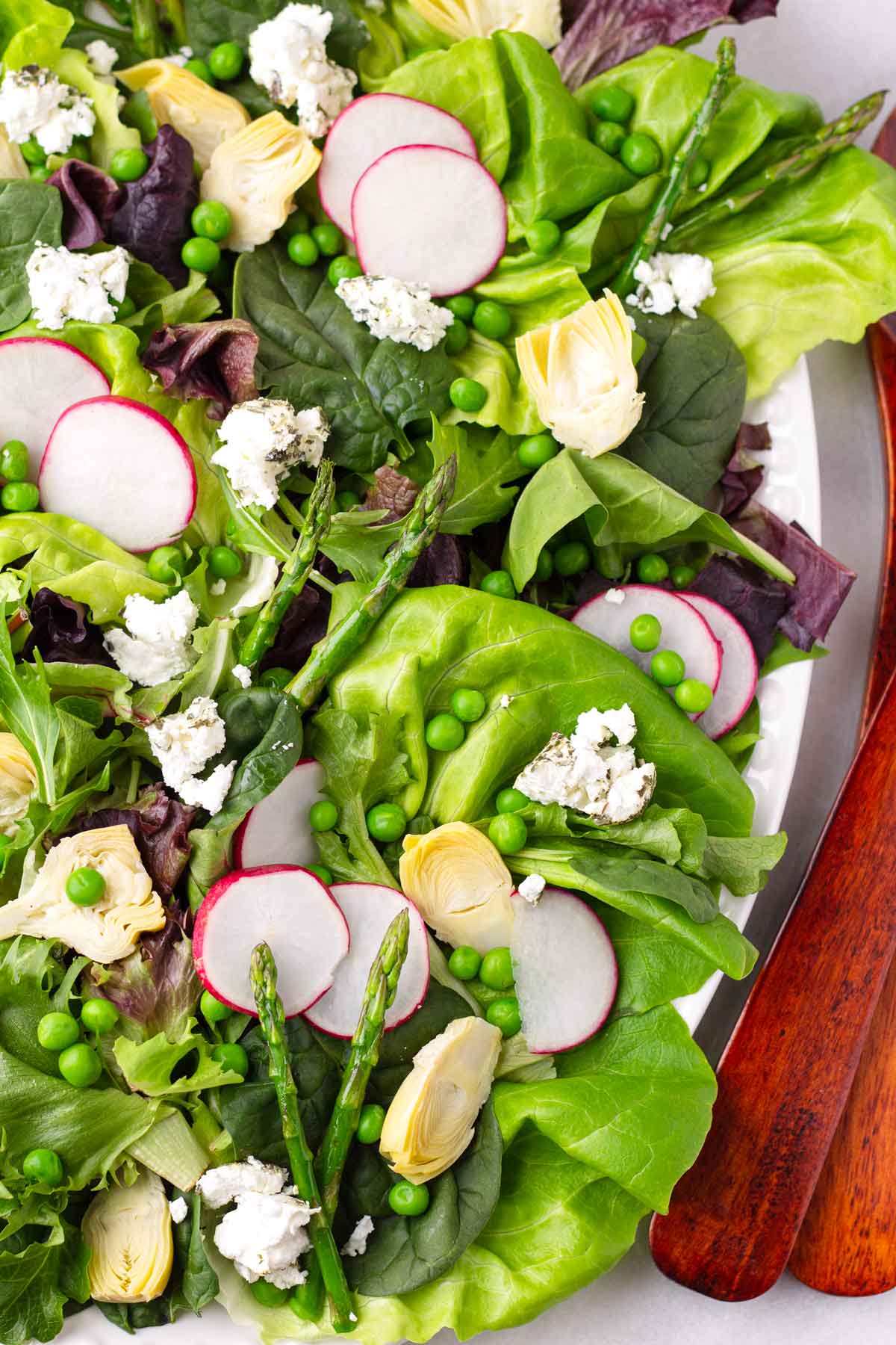 salad with greens, asparagus, peas, and radishes