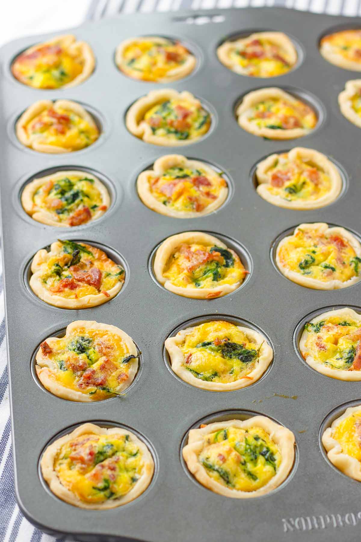 individual mini spinach quiches in baking pan