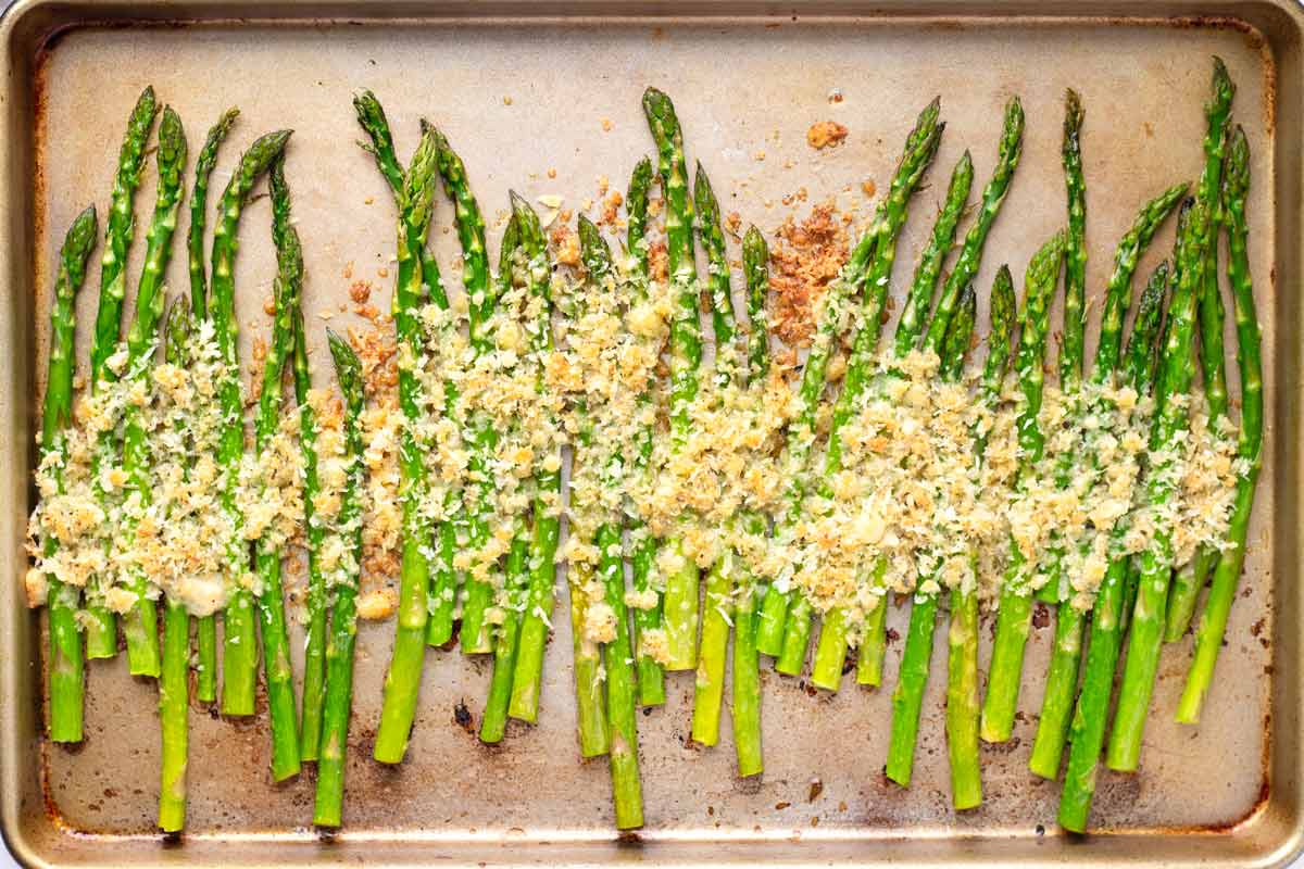 just baked asparagus with cheese topping on sheet pan