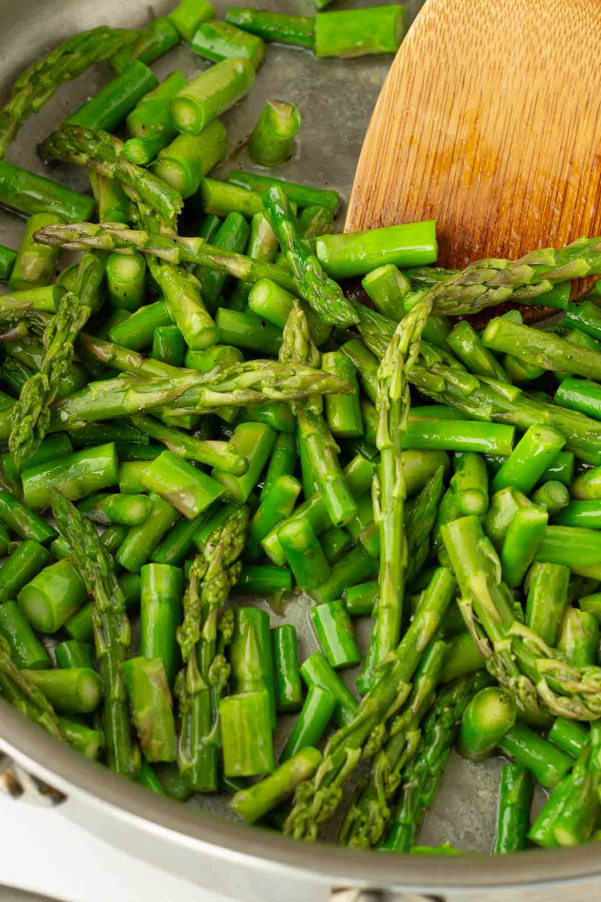 sauteing chopped asparagus in skillet