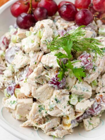 chicken salad with grapes garnished with herbs