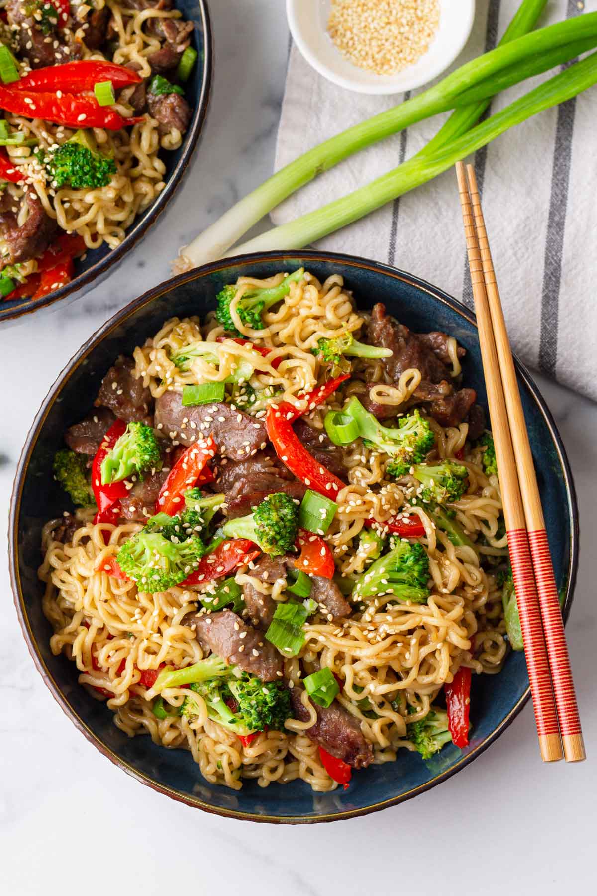 two bowls of beef and broccoli ramen stir fry