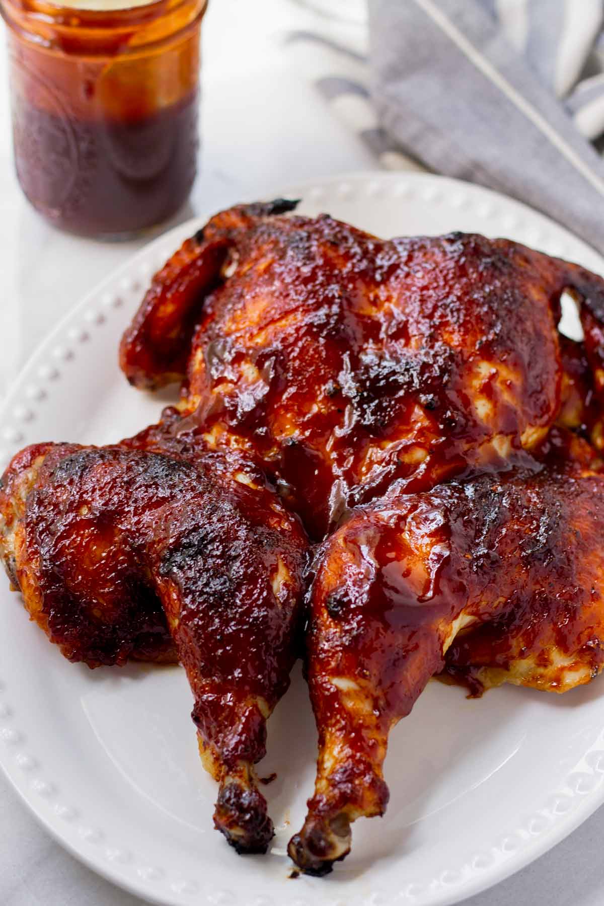 bbq spatchcocked chicken on an oval platter