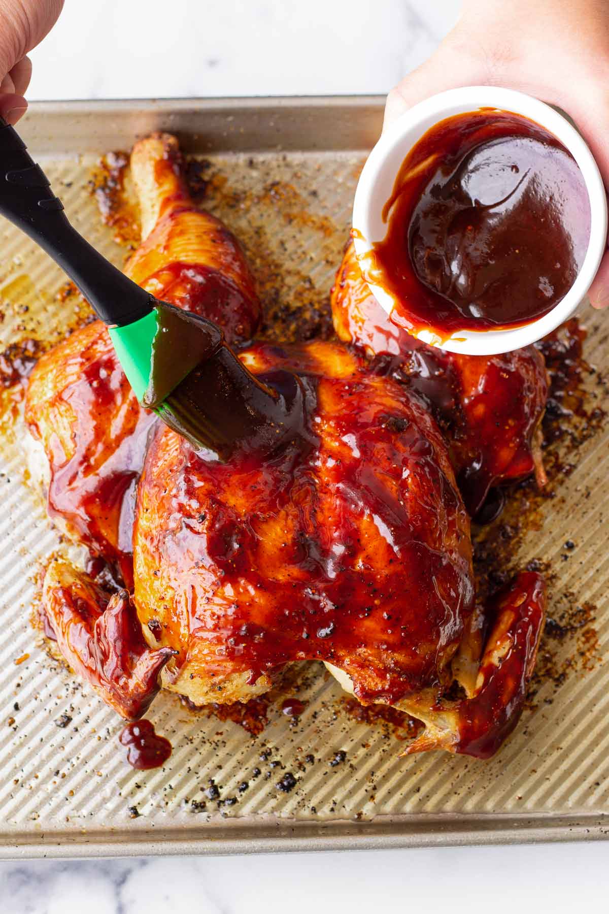 brushing chicken with bbq sauce