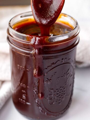 sweet bbq sauce in a mason jar with a spoon