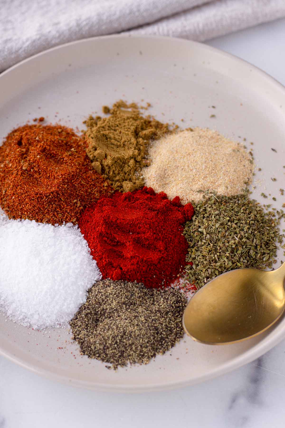spices for chicken taco seasoning arranged on a plate