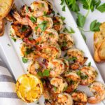four skewers of marinated shrimp