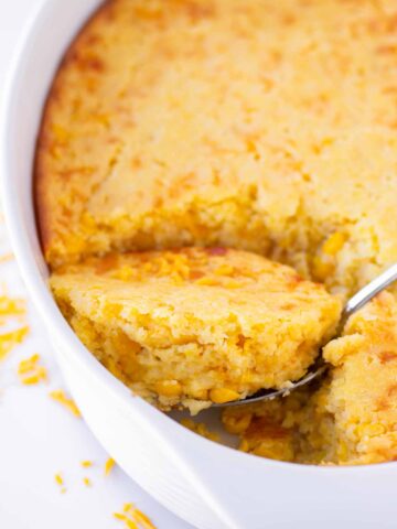 a spoon scooping a serving of baked corn casserole