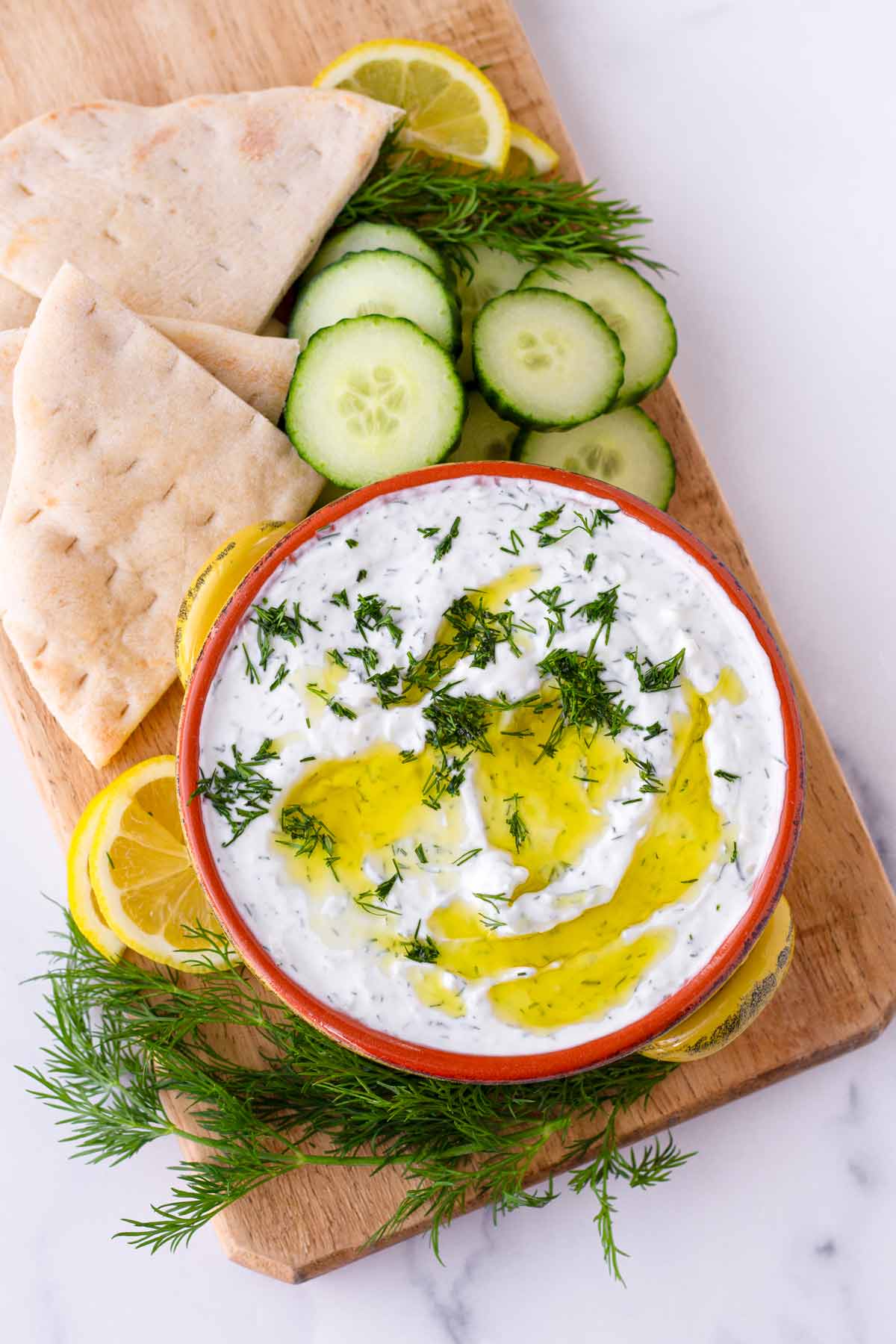 greek tzatziki with pita bread, cucumbers, and lemons