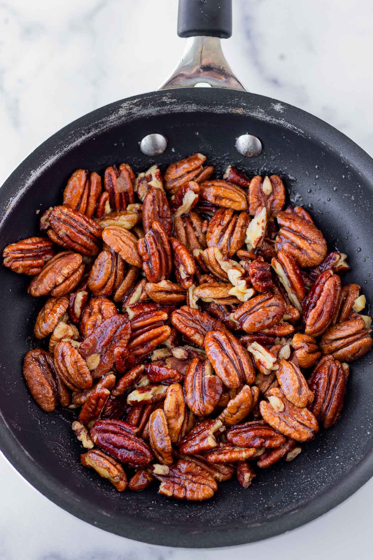 candied pecans on skillet