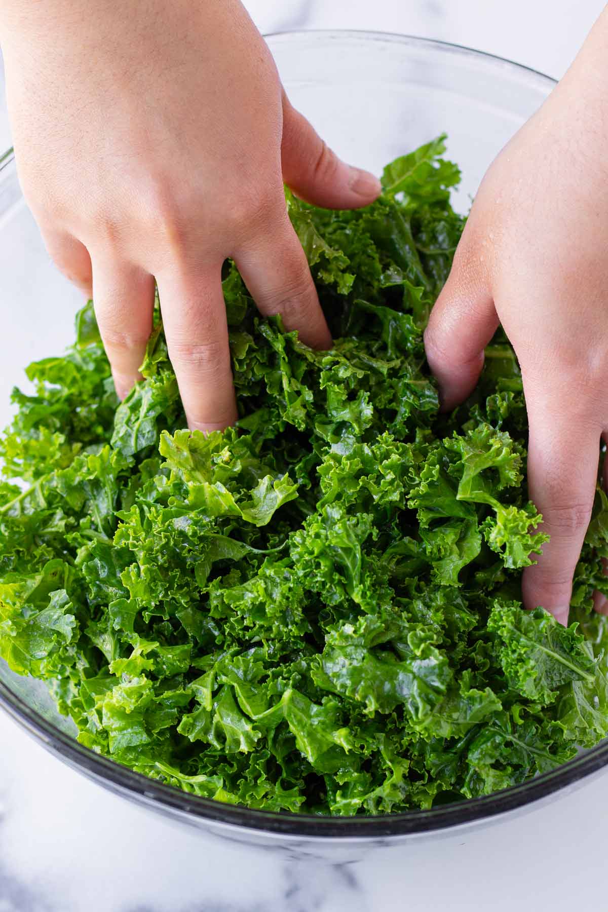massaging chopped kale to soften