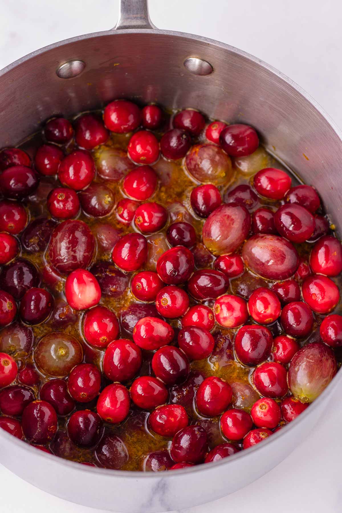 cooking cranberry sauce in a saucepan