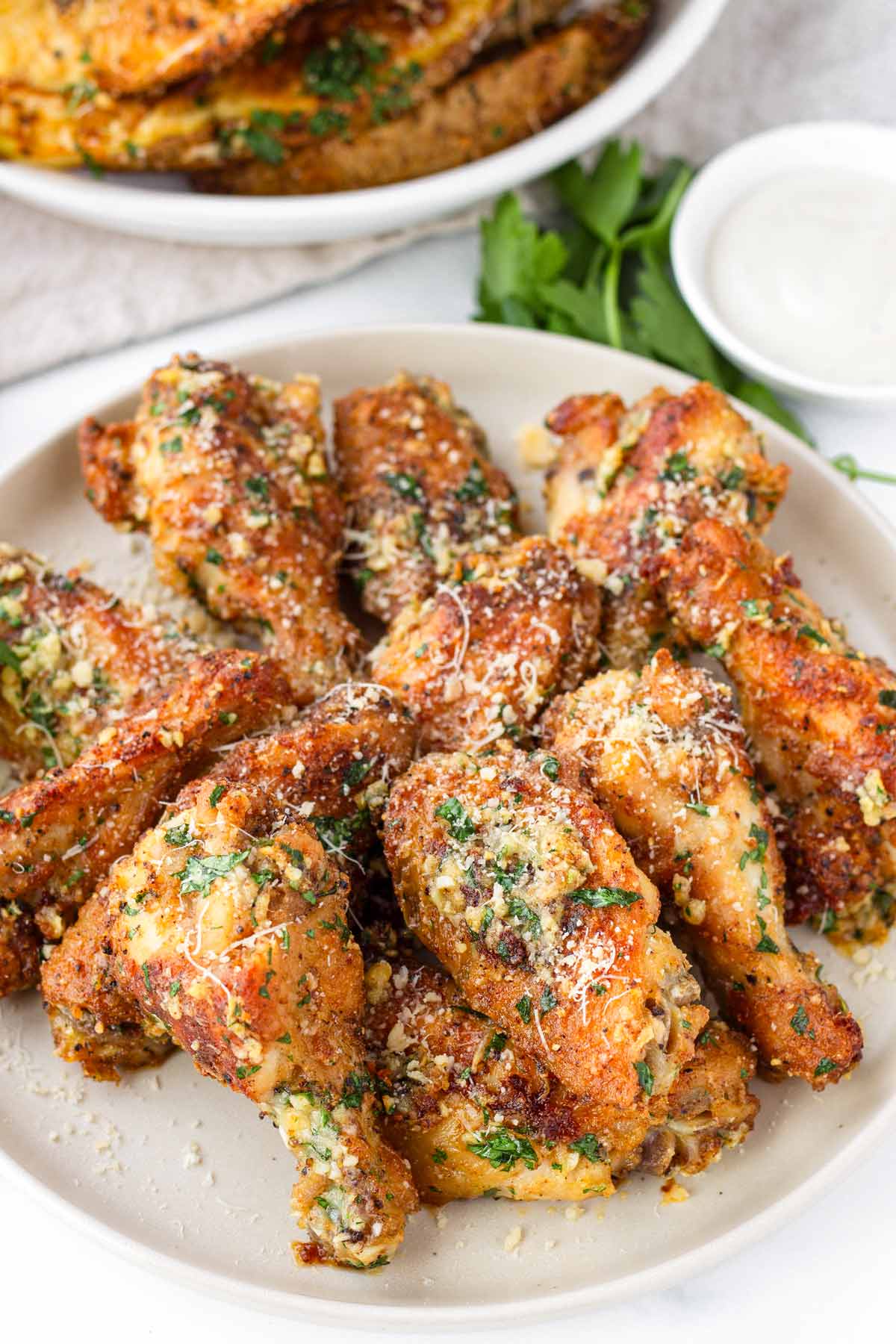 a plate with garnished garlic parmesan chicken wings