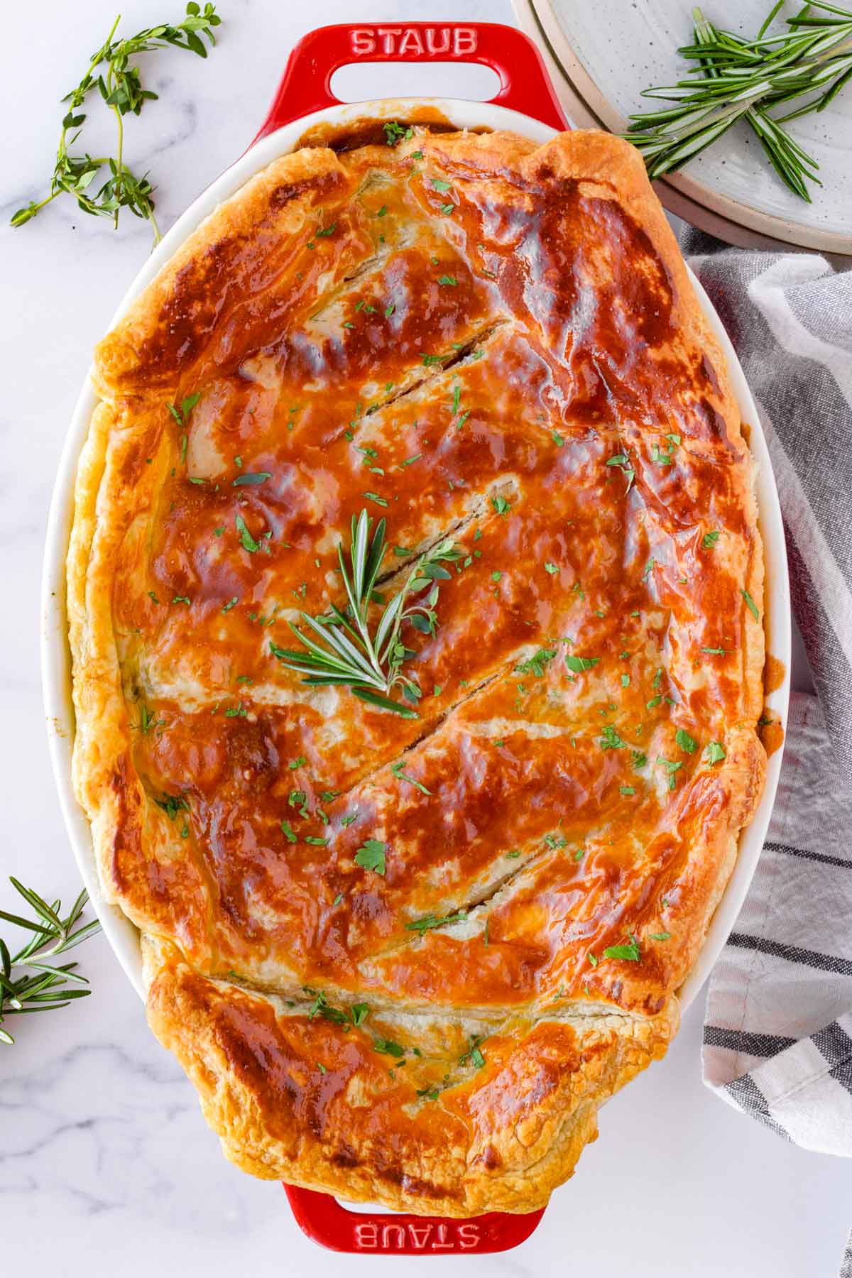 oval shaped baked pot pie with garnish