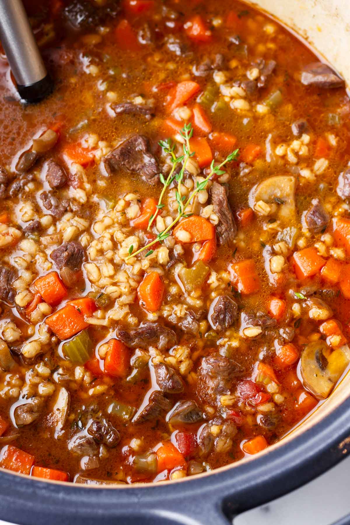 beef barley soup in a blue dutch oven