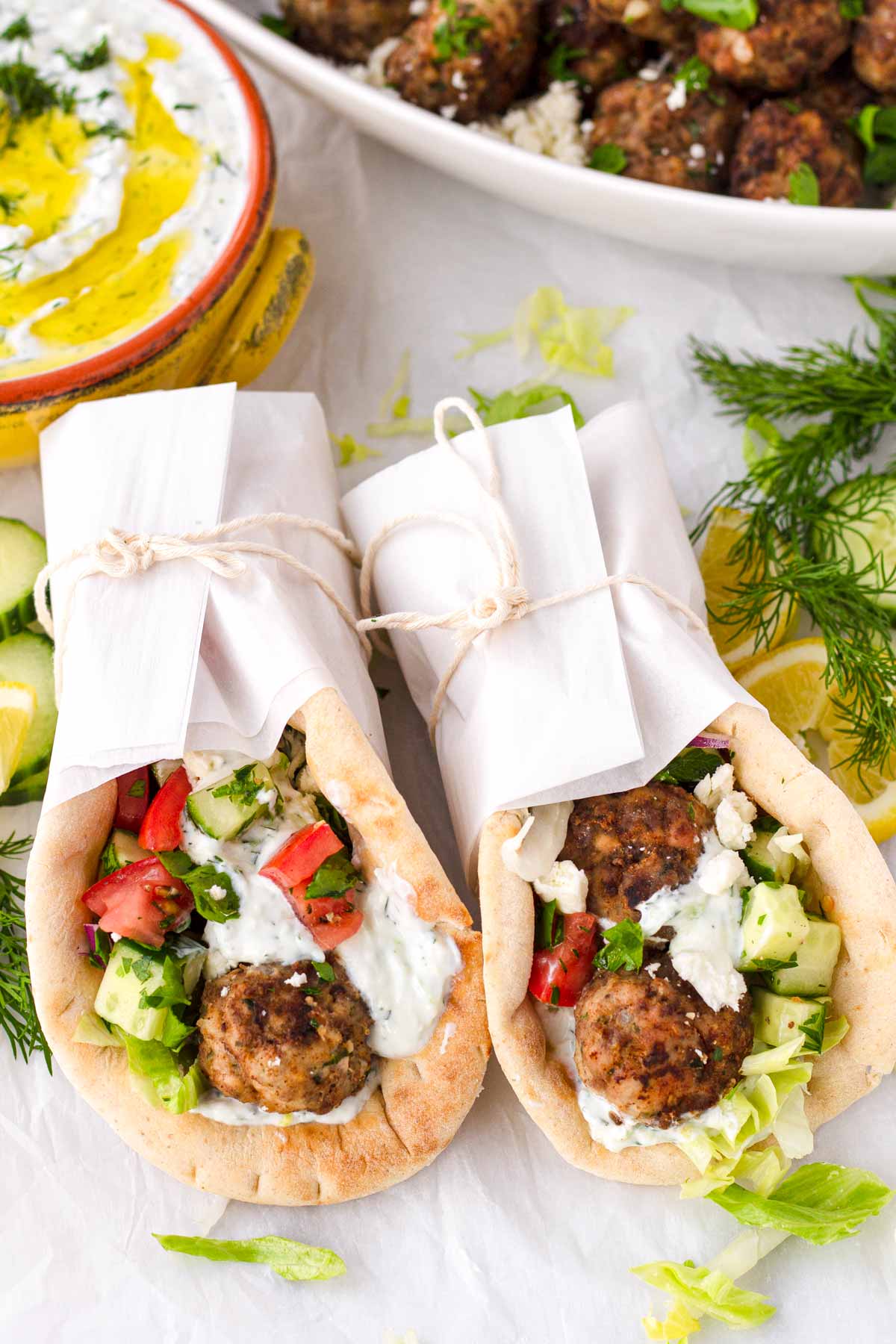 two pita wraps with parchment paper