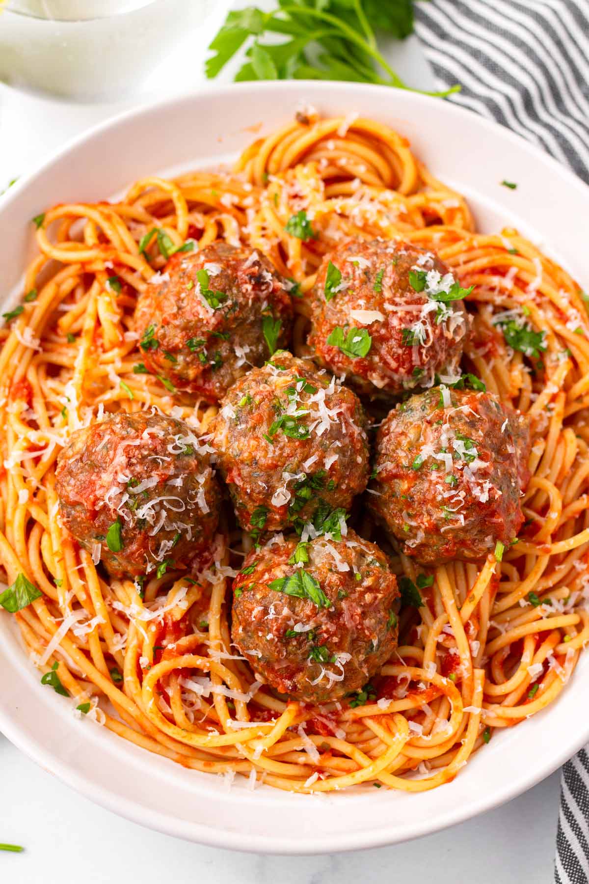 five italian meatballs on red sauce spaghetti
