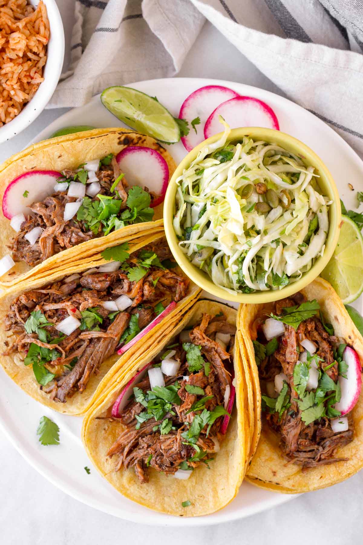 barbacoa tacos served with slaw and rice