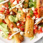 freshly fried chicken taquitos with toppings