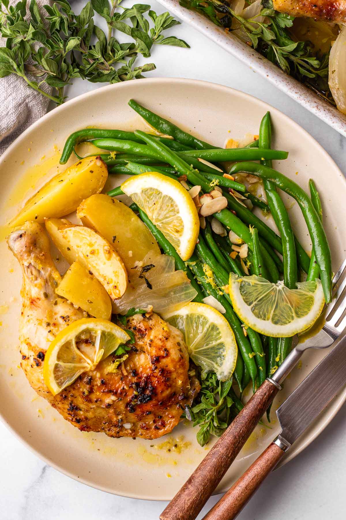 plate with side of greek lemon chicken, potatoes, and green beans