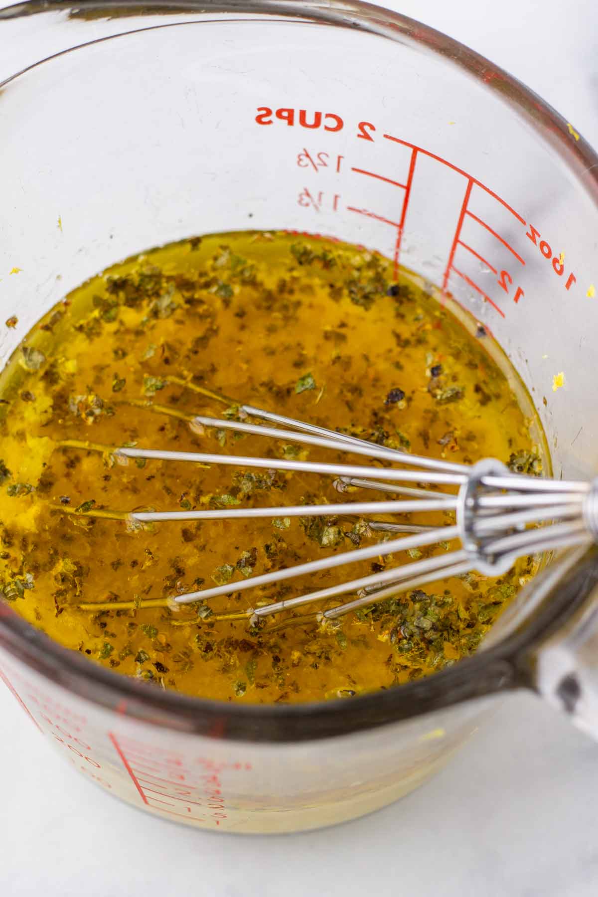 the lemon marinade in a measuring cup with whisk