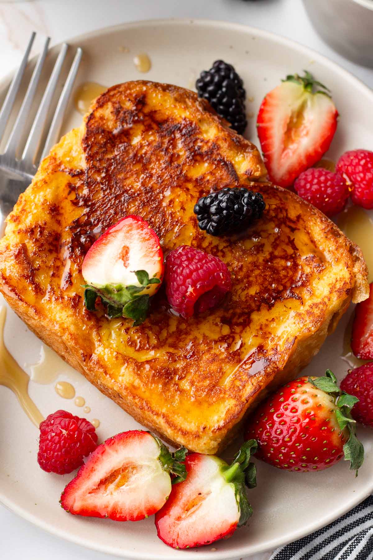 single french toast with berries and syrup