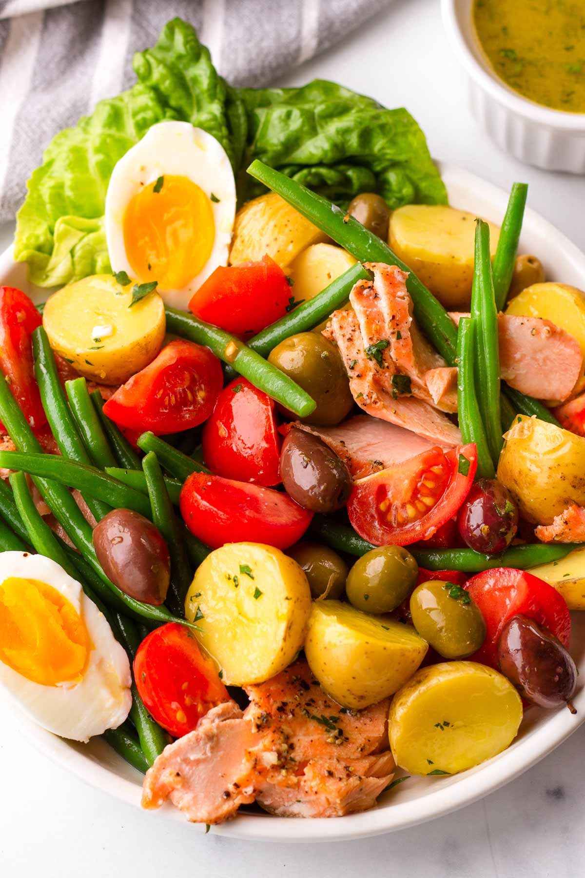 tossed salmon nicoise salad in plate