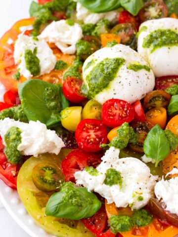 close up of tomato burrata salad with basil dressing