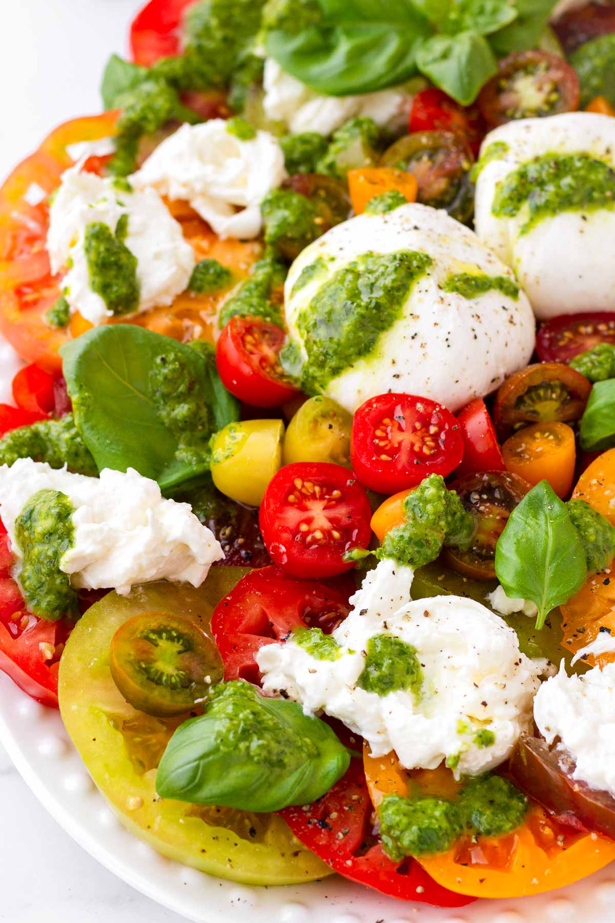 close up of tomato burrata salad with basil dressing
