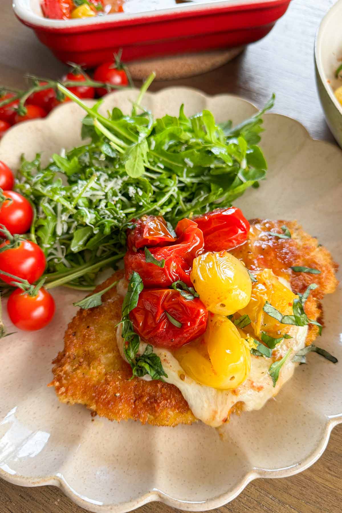 plate of summer chicken parmesan with greens