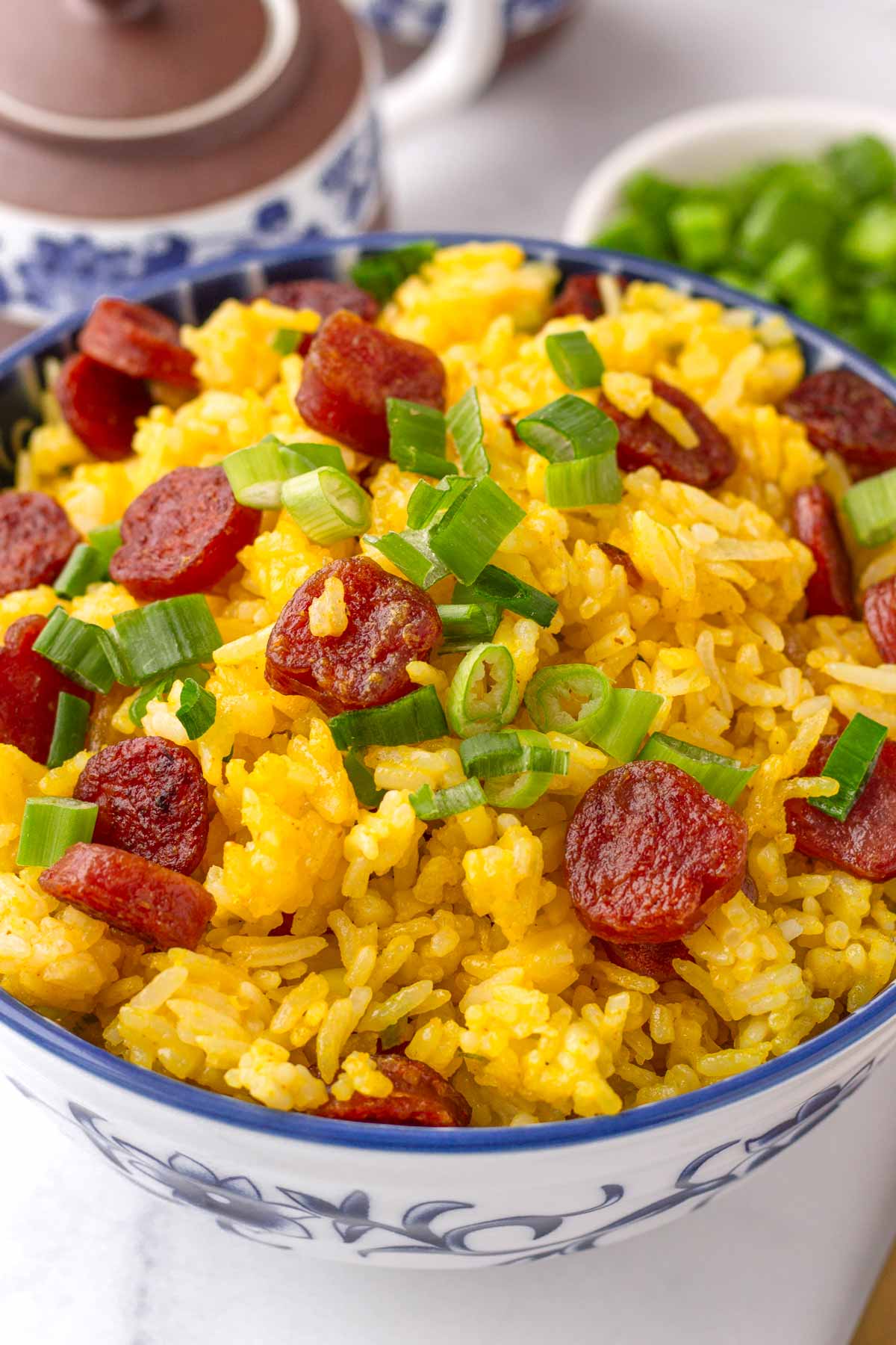 a serving of fried rice with protein in a blue bowl