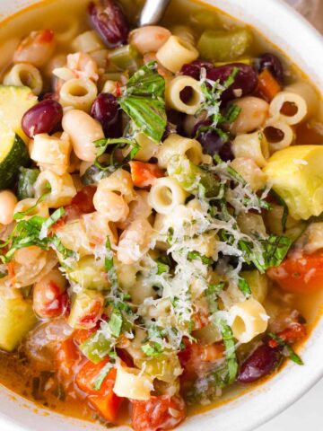 a bowl of minestrone soup with garnish