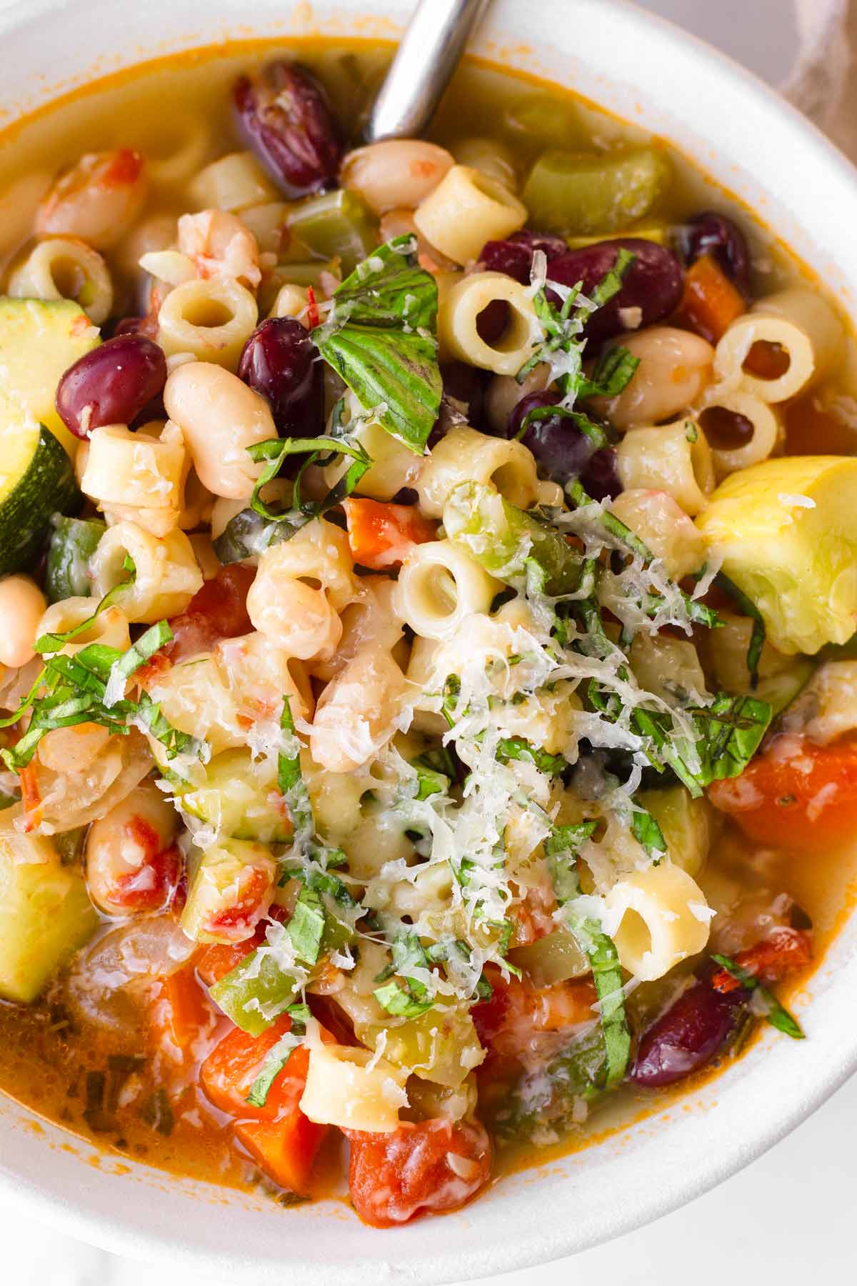 a bowl of minestrone soup with garnish