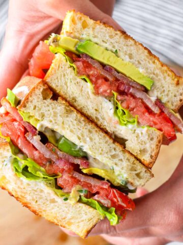 holding a blt with hands