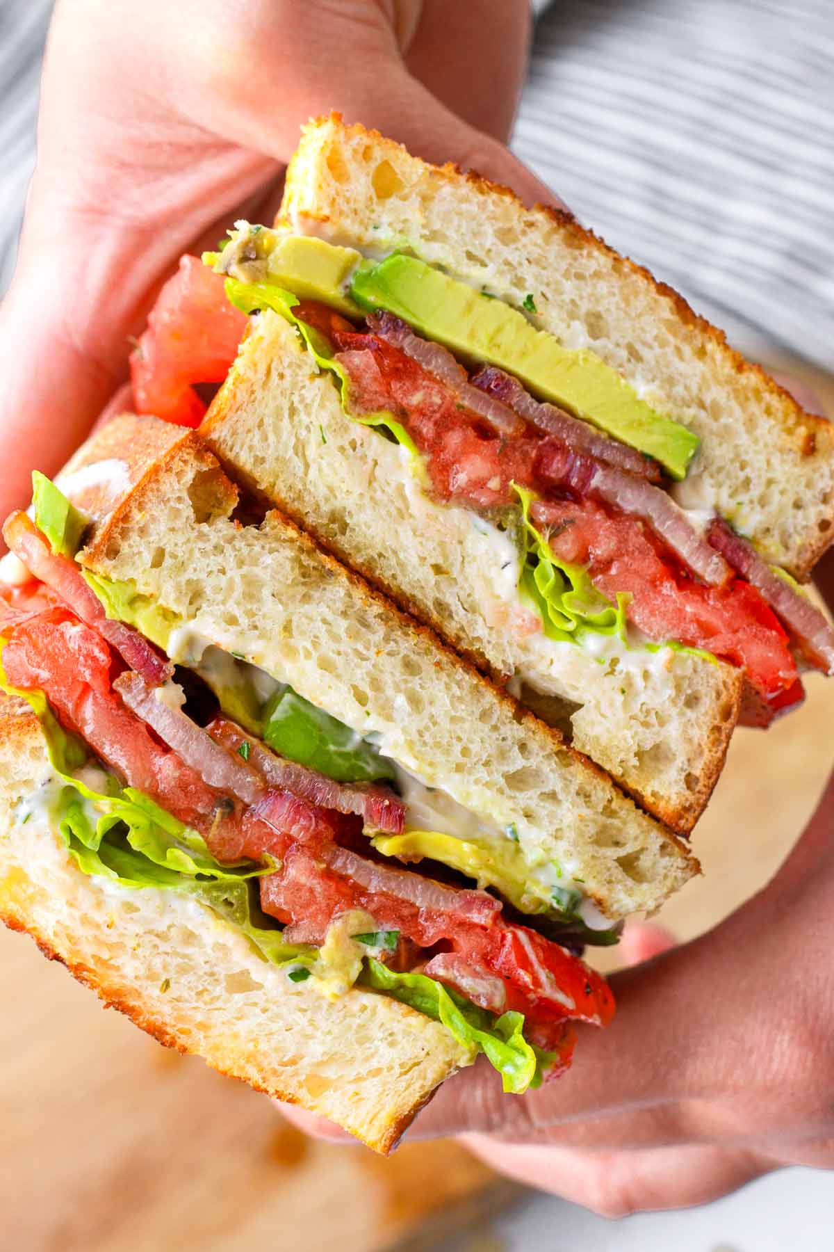 holding a blt with hands