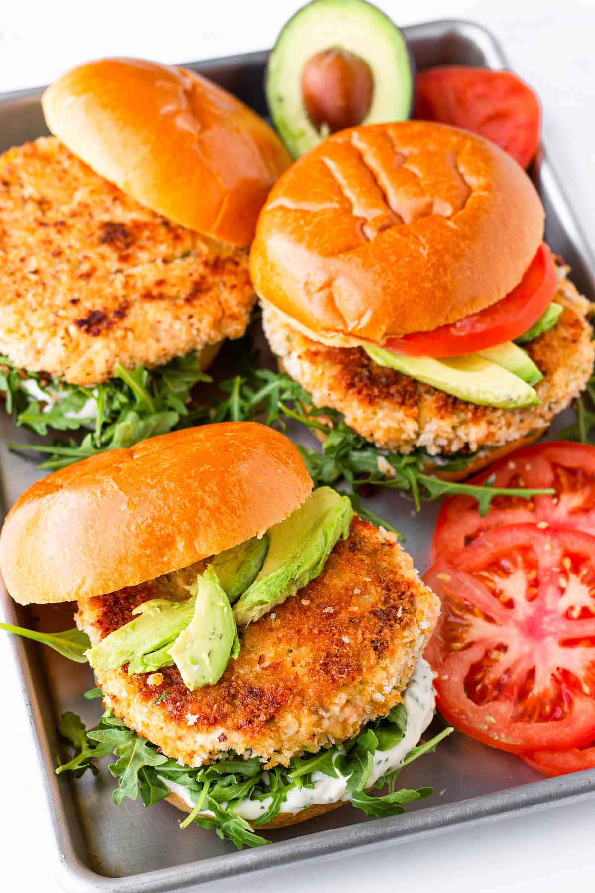 three salmon burgers on sheet pan