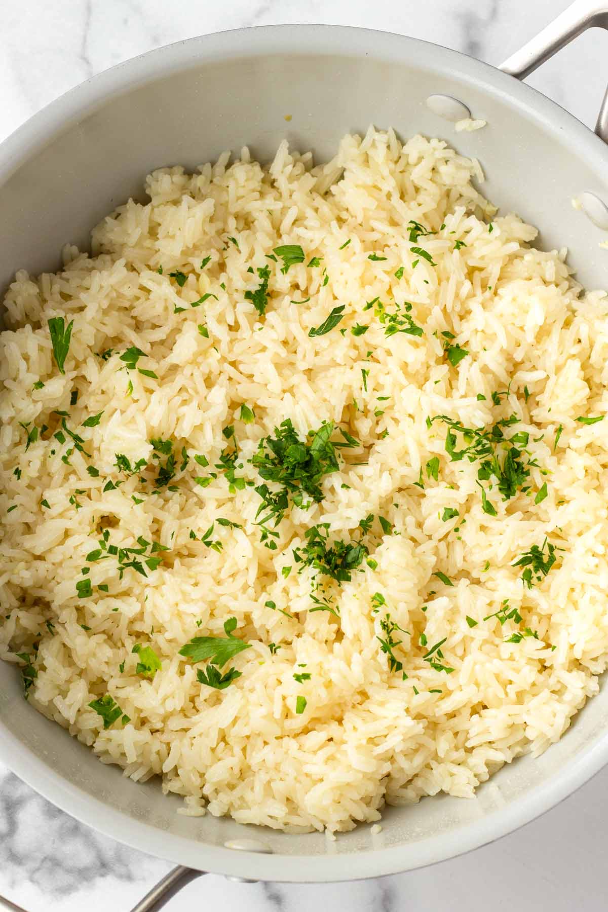 garlic butter rice with parsley garnish